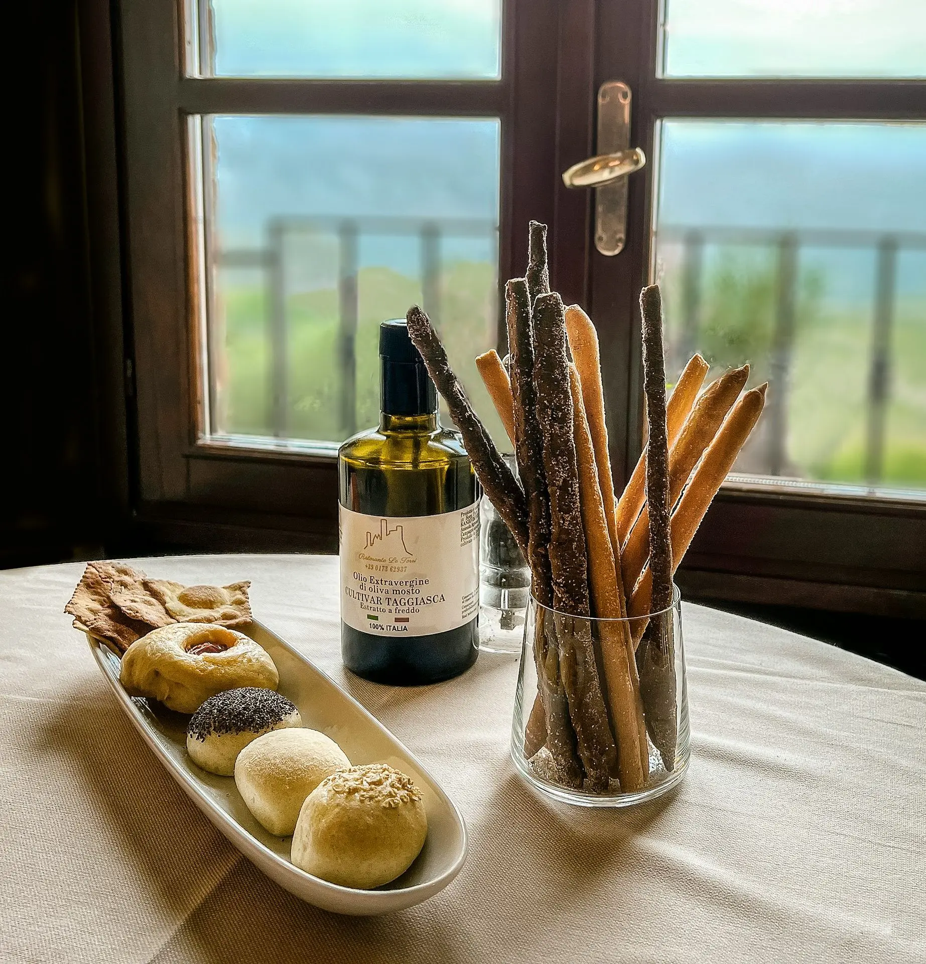a table with a bottle of wine and a plate of food